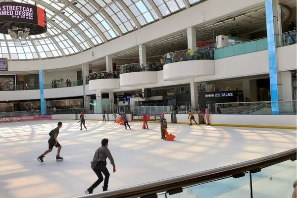 People ice skating at an indoor ice rink at West Edmonton Mall