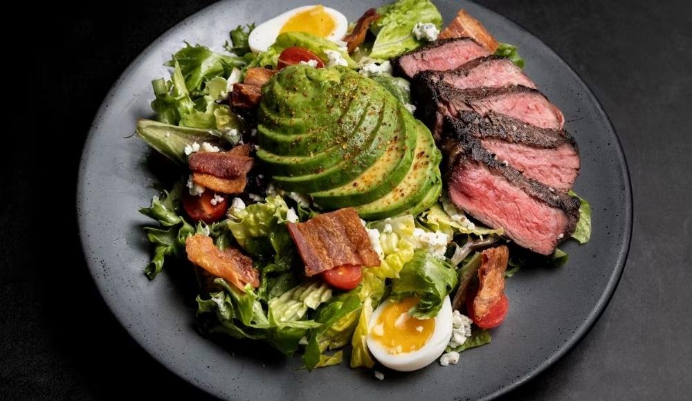 A salad with sliced avocado at Chop Steakhouse & Bar