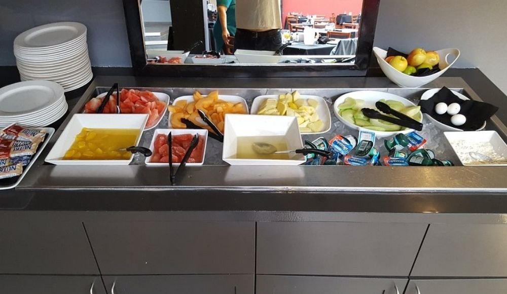 Discover the essence of buffets in Edmonton with a tempting spread featuring sliced fruits, butter packets, boiled eggs, and pristine plates, ready to elevate your dining experience.