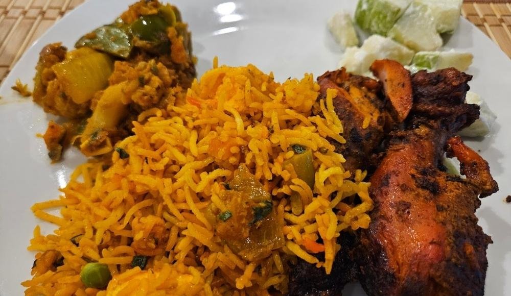 A plate of spiced rice, grilled chicken, at Madhuban Fine Indian Cuisine