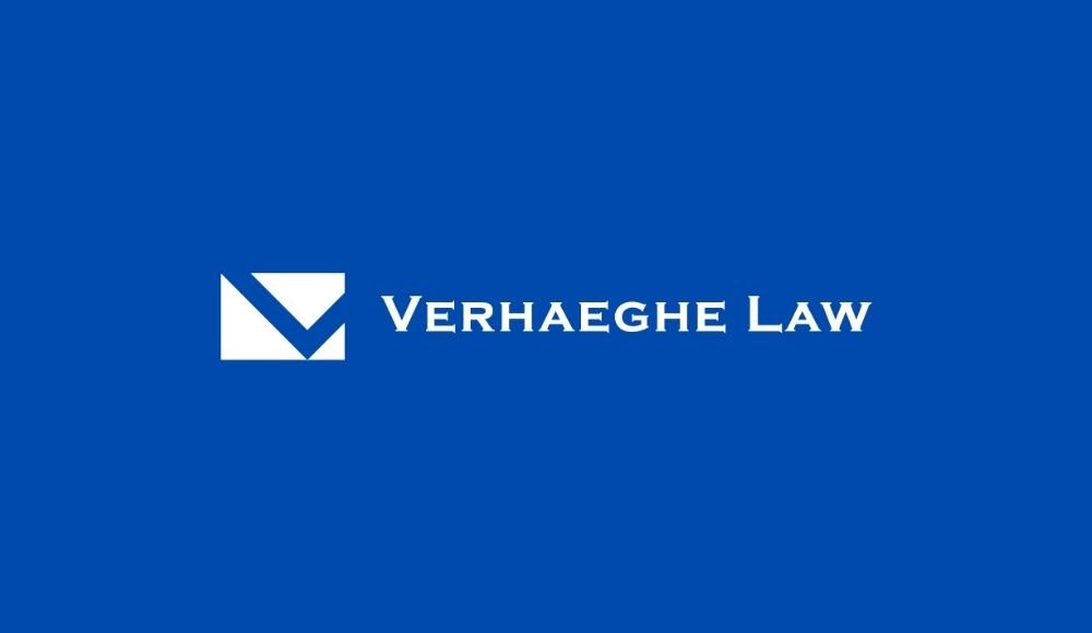 The logo of Verhaeghe Law, featuring a white geometric symbol and text against a blue backdrop, embodies the professionalism of divorce lawyers in Edmonton.