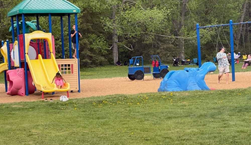 Children and adults at a playground at Wabamun Lake Provincial Park.