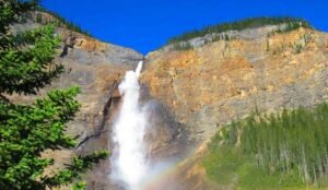 A tall Alberta waterfall cascades down a rocky cliff at Takakkaw Falls, Alberta