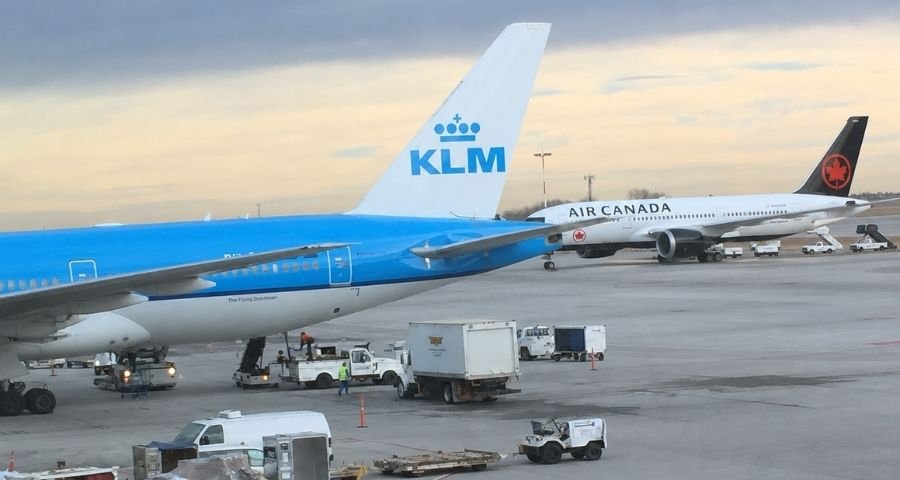 KLM and Air Canada airplanes are parked at Calgary International Airport.