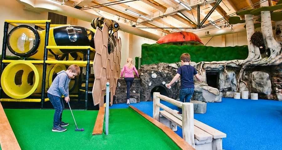 Three children play indoor at John Janzen Nature Centre, Edmonton