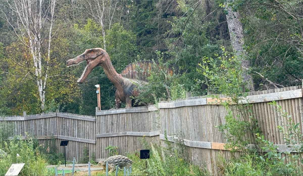 A dinosaur overlooking the 18-hole dinosaur mini golf course called Journey to Extinction.
